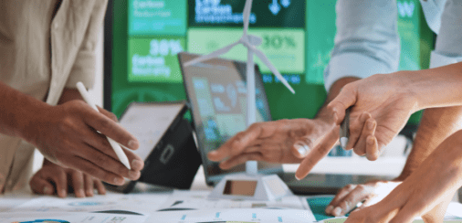 Hands pointing at eco-friendly charts and data
