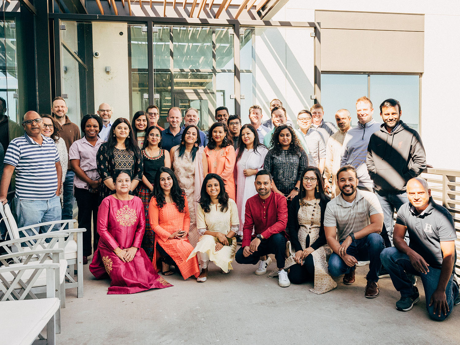 Diverse group smiling together outdoors.