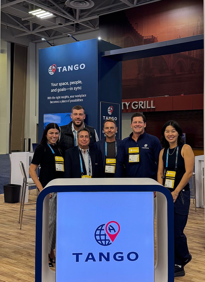 Group at Tango booth in convention center.
