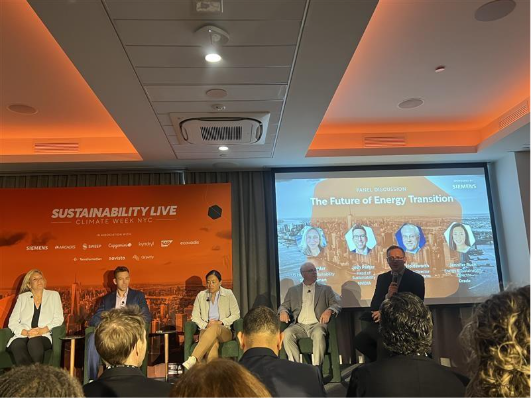 Panel discussing future of energy transition at conference.