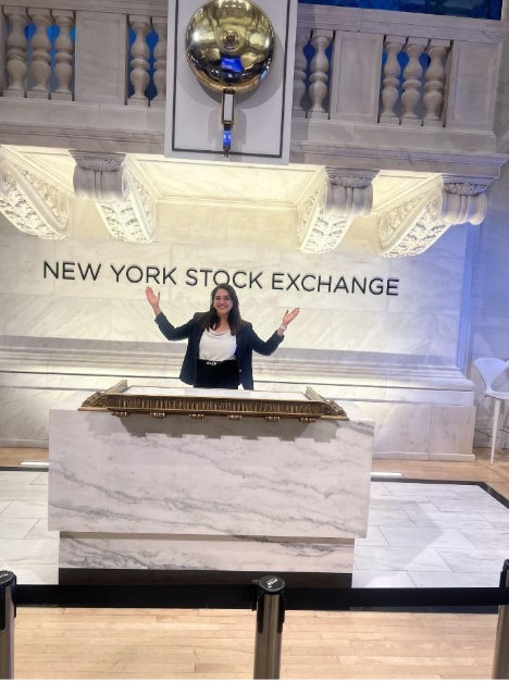 Person standing at New York Stock Exchange podium.
