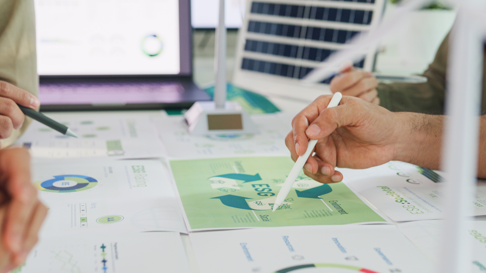 People discussing ESG report and charts.