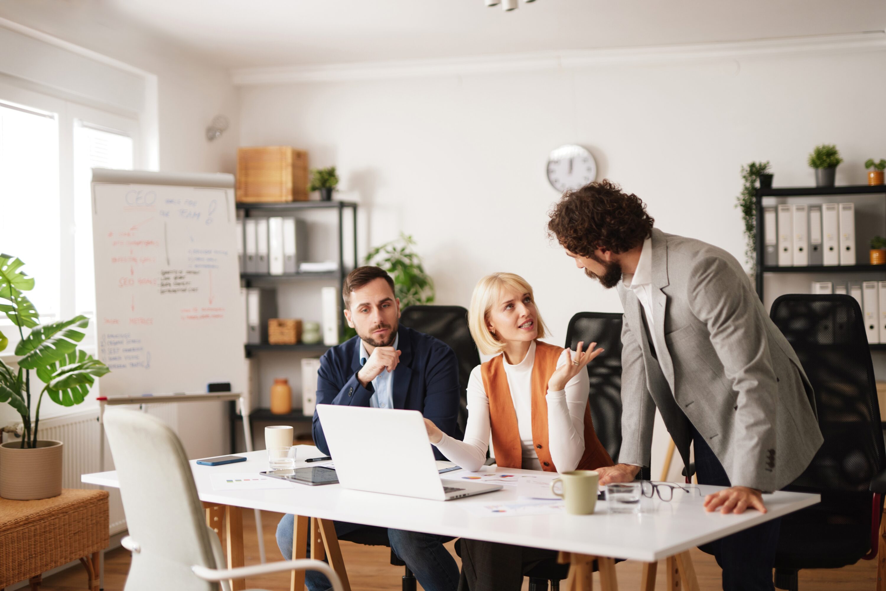 team,members,collaborate,in,a,bright,office,environment.,they,share
