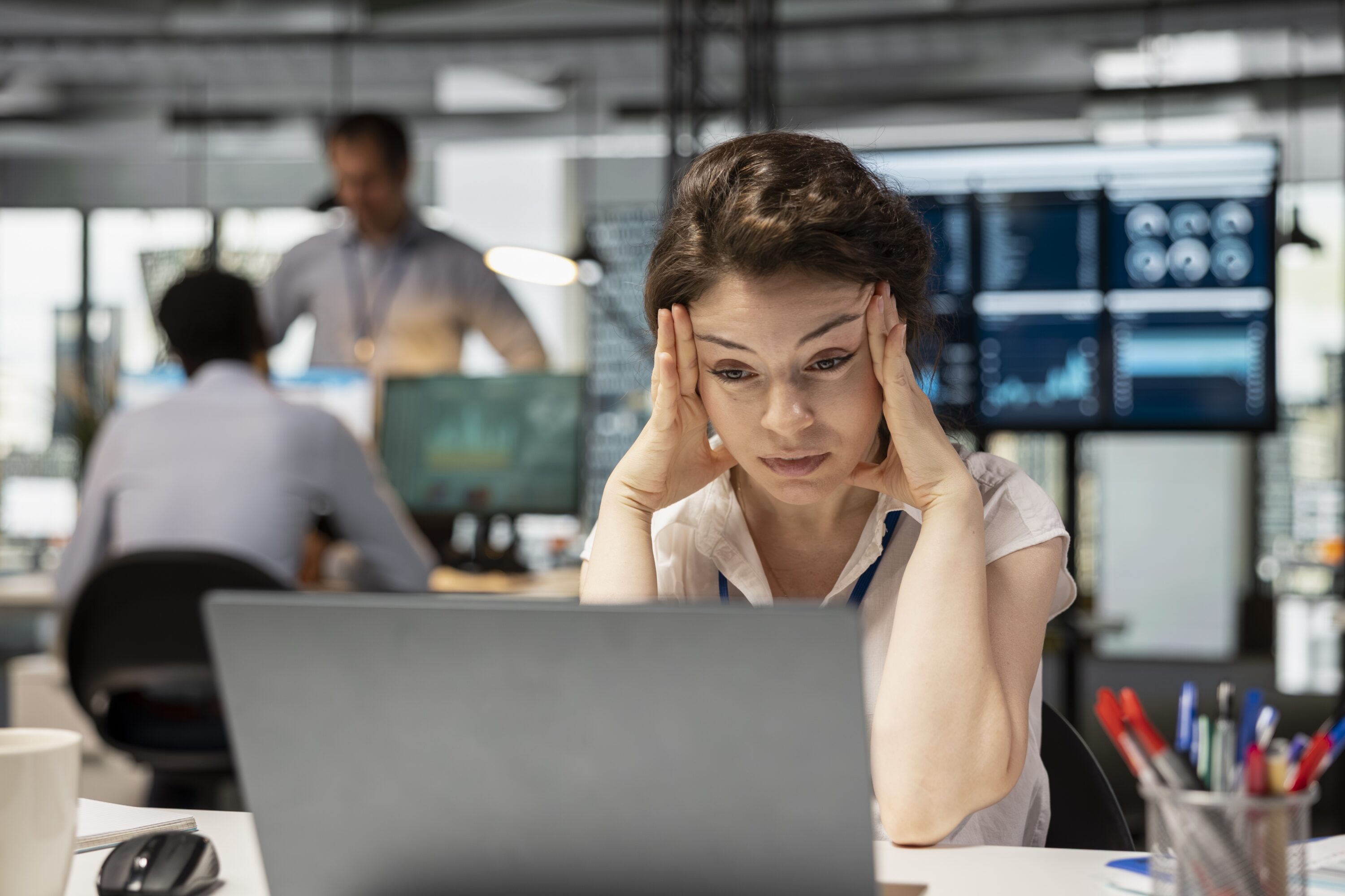 frustrated,female,office,worker,sits,at,desk,,feeling,stressed,and