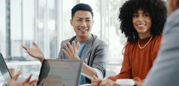 Diverse team in a meeting with laptops.