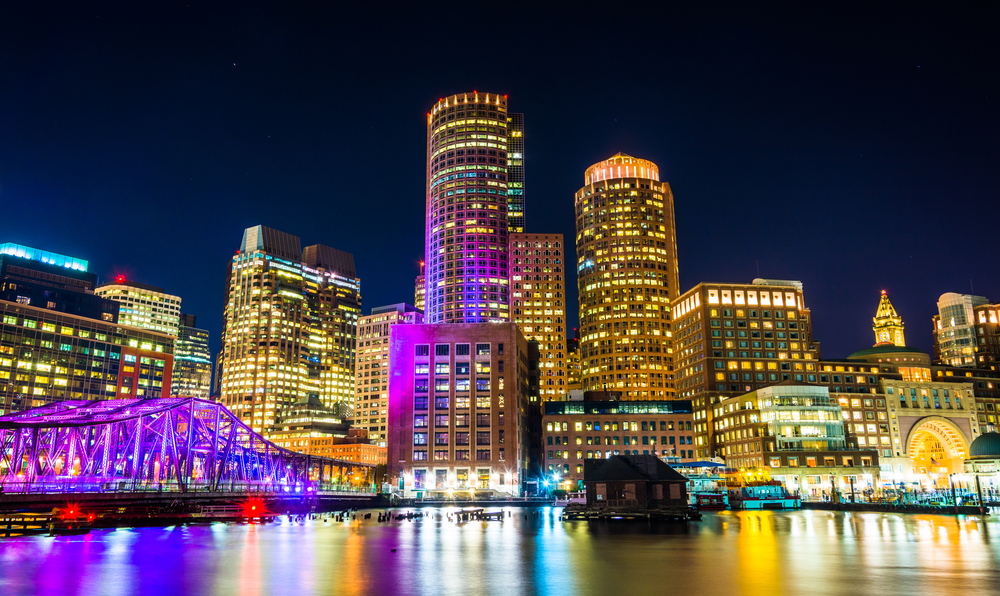 the boston skyline and fort point channel at night from fan pier park boston massachusetts.